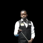 Pool player Ceaser Chadinga holding his cue during a pool game
