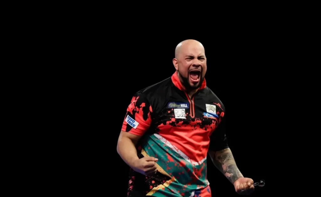 African darts legend Devon Petersen celebrating a darts match