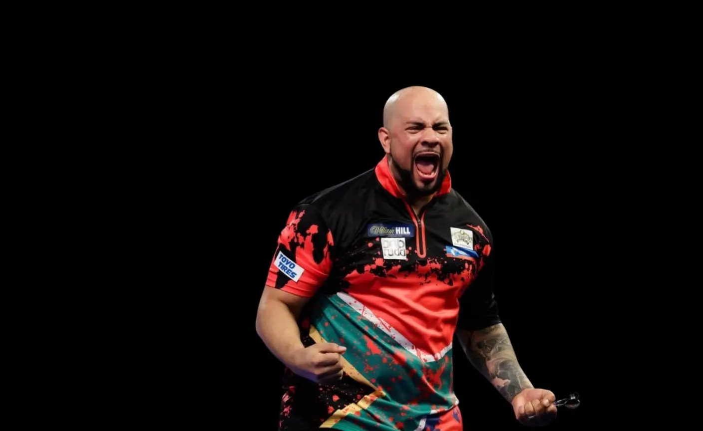 African darts legend Devon Petersen celebrating a darts match